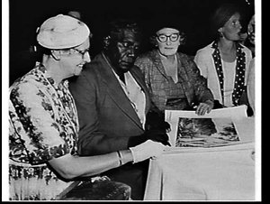Albert Namatjira signing some of his paintings for wome...