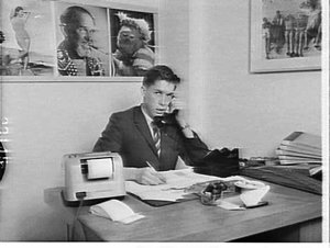 Advertiser at desk, John Smith with Philips advertising...
