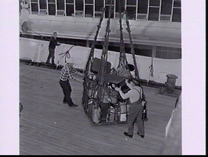 Baggage-handling using a cargo net and derrick on the P...