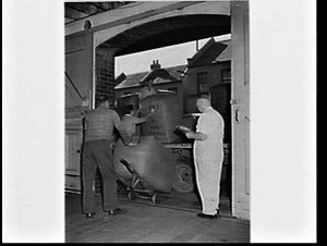 Unloading wool bales from a truck at Dalgety's store at...