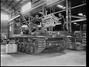 Engine of Centurion tank being positioned over the engi...