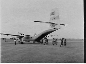 Army and Air Force personnel inspect the De Havilland C...