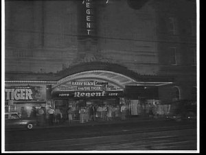 Exterior of Regent Theatre, at night, advertising the f...