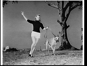 Model running with greyhound at Mrs. Macquarie's Chair