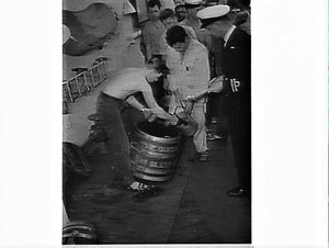 Doling out the rum ration on HMNZS Royalist after exerc...