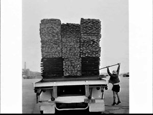Unloading timber from a semi-trailer using a fork-lift ...
