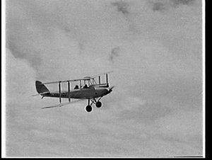 Biplane in flight at Aubrey Oates' picnic at Camden