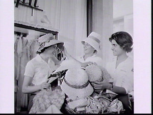 Runners Betty Cuthbert and Dixie Willis try on straw ha...