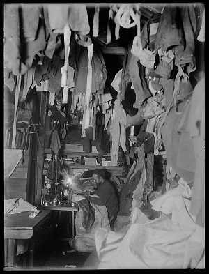 W048: Bage repairing his sleeping bag in a corner of th...