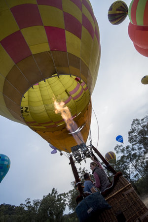 Item 04: Hot air balloon about to lift off into the daw...