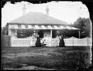 Women and children in front of Solander View, a single ...