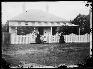 Women and children in front of Solander View, a single-...