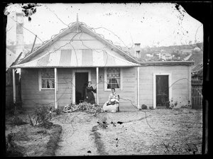 Two women in front of a weatherboard house, Hill End