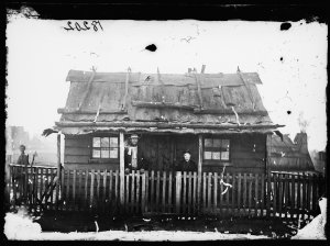 Couple and weatherboard cottage with bark roof, Gulgong