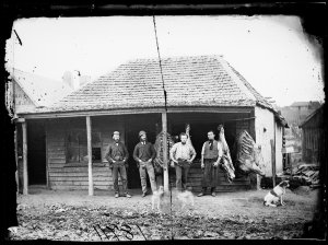 Butcher and three men outside butcher shop (formerly Kr...