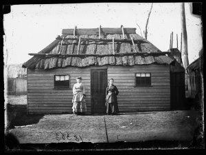 Two women outside house next door to the West Coast Hot...