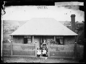 Louis Beyer's wife and children in front of their house...