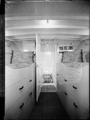 Forward cabin with bunks and bathroom of cabin cruiser ...