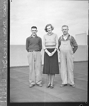 Group of two men and a woman, maintenance staff (?) on ...