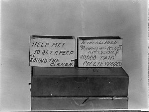 Unemployed match-seller's sign: Help me! to get a peep ...