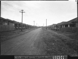 Unmade suburban street with houses on each side (taken ...
