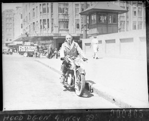 Salesman demonstrating a Francis-Barnett motorcycle