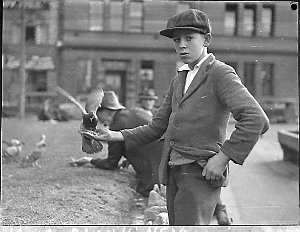 Boy with pigeons at the Quay