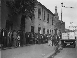 Long queue of men with suitcases, George Street, The Ro...