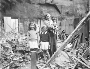 Mother, two children and pet dog amidst the rubble of a...