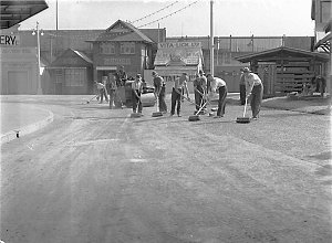 Ten workmen sweeping the footpaths outside the cattle p...