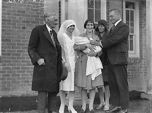 Mother and baby in group with nurses, unidentified doct...