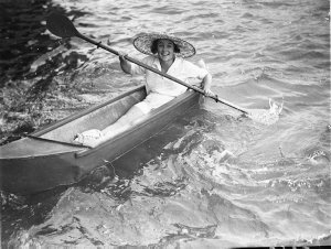 A girl paddling her dinghy