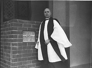 Rev. Frederick Hugh Hordern beside the plaque: "Parish ...