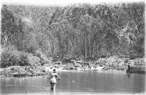 A man fishing in a mountain stream