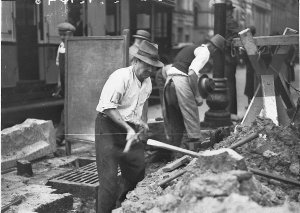 Workmen concreting footpaths near the city markets