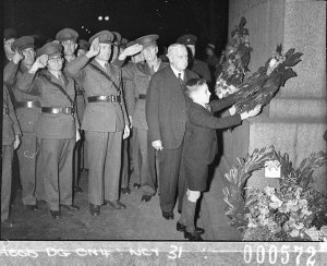 A boy places a wreath on the Cenotaph, YMCA Centenary