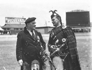Two Highland pipers talking together at the Highland So...