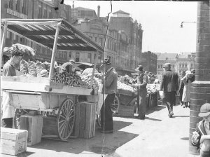 Three fruit barrows selling on a city street