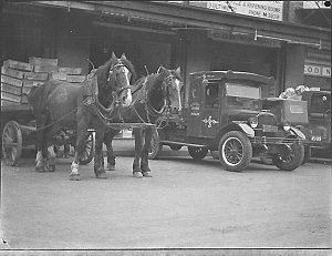 Loading dock with delivery trucks and horsedrawn drays