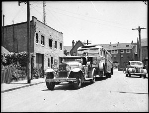 Motor bus being towed to Queensland, 1929 Cadillac towt...