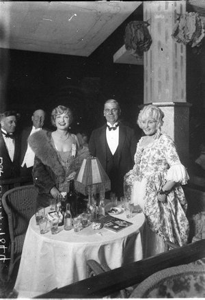 Two women and a man in evening dress at the Movie Ball,...