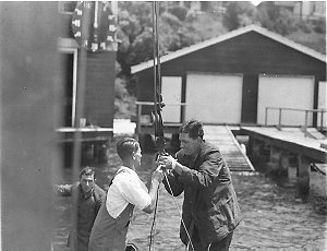 Driver and mechanic preparing a sling to lift their cra...