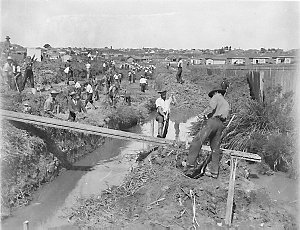 Depression relief workers digging a stormwater canal