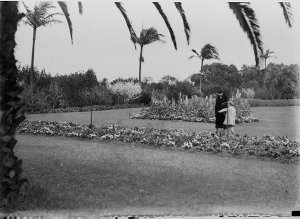 Unidentified woman and girl in a garden