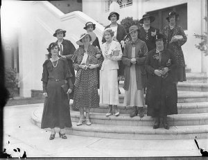 Group of women on the porch of a mansion