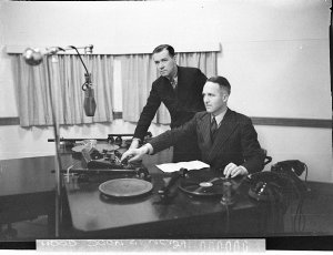 Radio station 2GZ. Two men operating the panel and turn...