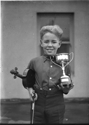 Young violinist and his trophy at Eisteddfod