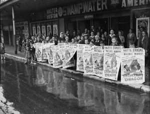 Children hold posters advertising Walt Disney's "Reluct...