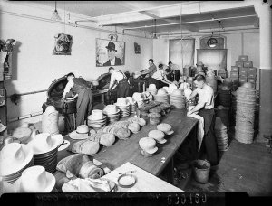 Men operators steam-blocking and pressing hats at Sargo...