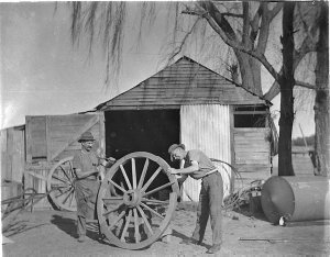 Wheelwrights working on a wagon wheel at Berridale, nea...